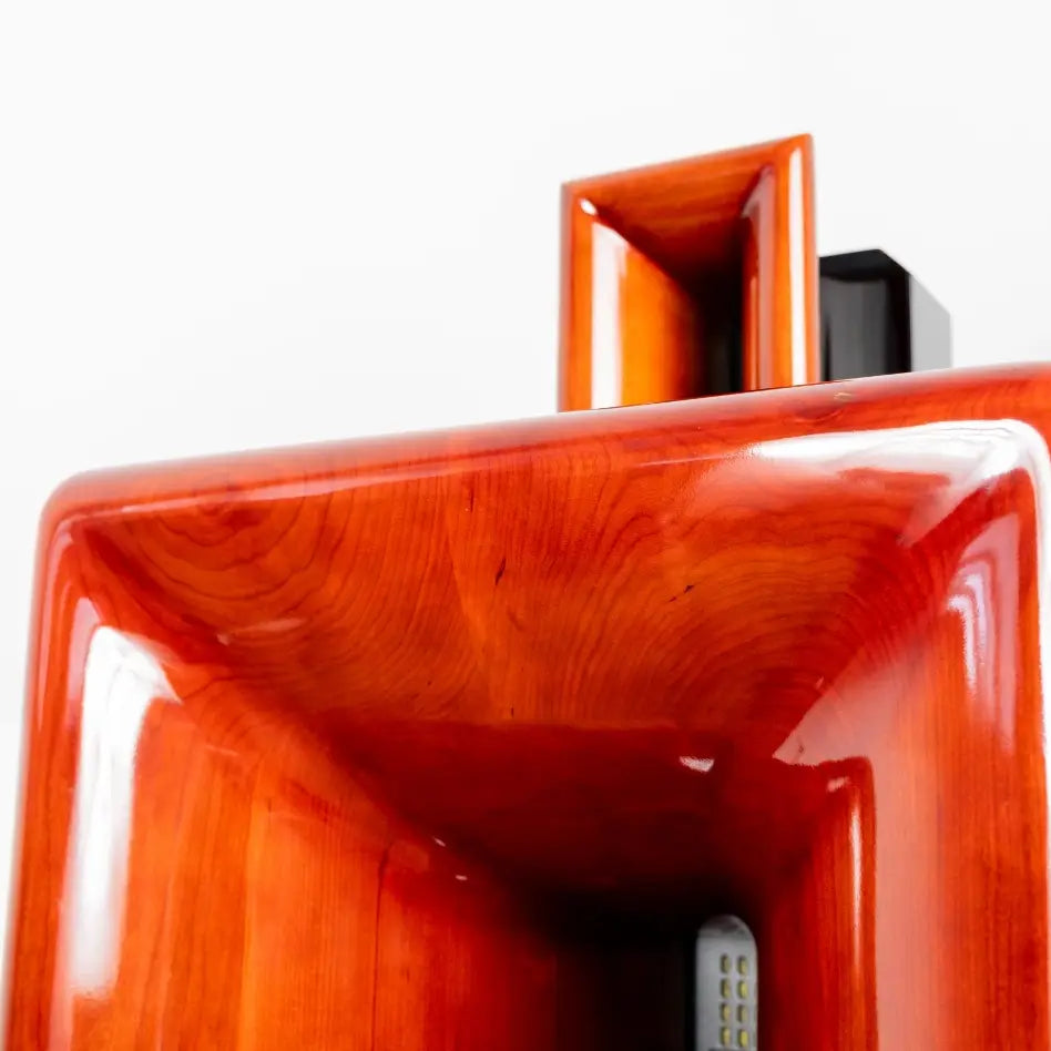 Close-up of a red electronic device with a white background