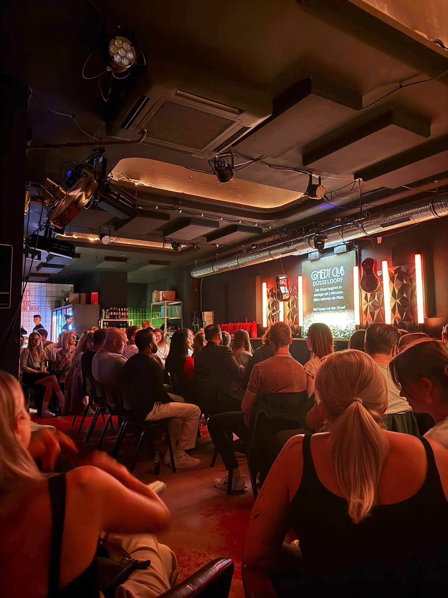People watching a performance or event in a theater or auditorium.